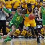 Oregon's Kenny Wooten (14) tries to steal the ball from Arizona State's Zylan Cheatham during the first half of an NCAA college basketball game in the semifinals of the Pac-12 men's tournament Friday, March 15, 2019, in Las Vegas. (AP Photo/John Locher)