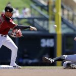 Arizona Diamondbacks second baseman Ildemaro Vargas, left, throws to first after forcing out San Francisco Giants' Joe Panik, right, at second in the first inning of a spring training baseball game Thursday, March 14, 2019, in Scottsdale, Ariz. Giants' Buster Posey was out at first base on the double play. (AP Photo/Elaine Thompson)