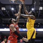 Arizona State's Romello White, right, shoots over St. John's Marvin Clark II (13) during the first half of a First Four game of the NCAA men's college basketball tournament Wednesday, March 20, 2019, in Dayton, Ohio. (AP Photo/John Minchillo)