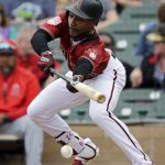 Arizona Diamondbacks' Jarrod Dyson tries to lay down a bunt against the Los Angeles Angels during the third inning of a spring training baseball game Thursday, March 21, 2019, in Scottsdale, Ariz. (AP Photo/Elaine Thompson)