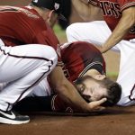 Arizona Diamondbacks' Steven Souza Jr. lies on the field and is assisted by manager Torey Lovullo, left, after getting injured while scoring against the Chicago White Sox in the fourth inning of a spring training baseball game Monday, March 25, 2019, in Phoenix, Ariz. (AP Photo/Elaine Thompson)