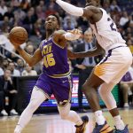 Utah Jazz guard Donovan Mitchell (45) drives as Phoenix Suns center Deandre Ayton defends during the first half of an NBA basketball game Wednesday, March 13, 2019, in Phoenix. (AP Photo/Matt York)