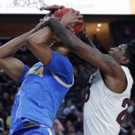 Arizona State's Romello White, right, fouls UCLA's Moses Brown during the first half of an NCAA college basketball game in the quarterfinals of the Pac-12 men's tournament Thursday, March 14, 2019, in Las Vegas. (AP Photo/John Locher)