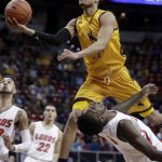 Wyoming's Justin James shoots over New Mexico's Jalen Harris during the first half of an NCAA college basketball game in the Mountain West Conference men's tournament Wednesday, March 13, 2019, in Las Vegas. (AP Photo/Isaac Brekken)