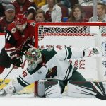 Minnesota Wild goaltender Devan Dubnyk (40) makes a save on a shot by Arizona Coyotes center Derek Stepan (21) during the first period of an NHL hockey game Sunday, March 31, 2019, in Glendale, Ariz. (AP Photo/Ross D. Franklin)