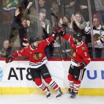 Chicago Blackhawks left wing Brendan Perlini (11) celebrates with defenseman Brent Seabrook (7) after scoring against the Arizona Coyotes during the first period of an NHL hockey game Monday, March 11, 2019, in Chicago. (AP Photo/Kamil Krzaczynski)