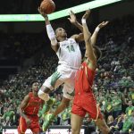 Oregon's Kenny Wooten, center, shoots between Arizona's Devonaire Doutrive, left, and Chase Jeter during the first half of an NCAA college basketball game Saturday, March 2, 2019, in Eugene, Ore. (AP Photo/Chris Pietsch)