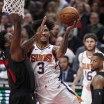 Phoenix Suns forward Kelly Oubre Jr., right, shoots as Portland Trail Blazers forward Al-Farouq Aminu, left, defends during the first half of an NBA basketball game in Portland, Ore., Saturday, March 9, 2019. (AP Photo/Steve Dipaola)