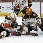 Anaheim Ducks goaltender Ryan Miller (30) and Korbinian Holzer cover up the puck in the second period during an NHL hockey game against the Arizona Coyotes, Thursday, March 14, 2019, in Glendale, Ariz. (AP Photo/Rick Scuteri)