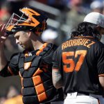 San Francisco Giants catcher Buster Posey, left, heads off the mound after talking with starting pitcher Dereck Rodriguez in the fourth inning of a spring training baseball game against the Arizona Diamondbacks, Thursday, March 14, 2019, in Scottsdale, Ariz. (AP Photo/Elaine Thompson)