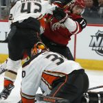 Anaheim Ducks goaltender Ryan Miller (30) covers up the puck as Josh Manson (42) clears Arizona Coyotes center Alex Galchenyuk (17) from the crease during the second period during an NHL hockey game Thursday, March 14, 2019, in Glendale, Ariz. (AP Photo/Rick Scuteri)
