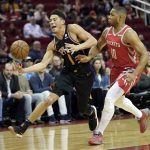 Phoenix Suns' Devin Booker (1) reaches for the ball as Houston Rockets' Eric Gordon (10) defends during the first half of an NBA basketball game Friday, March 15, 2019, in Houston. (AP Photo/David J. Phillip)