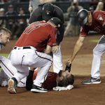 Arizona Diamondbacks' Steven Souza Jr. lies on the field and is assisted after getting injured while scoring against the Chicago White Sox in the fourth inning of a spring training baseball game Monday, March 25, 2019, in Phoenix, Ariz. (AP Photo/Elaine Thompson)