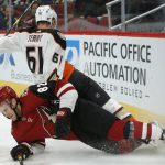 Arizona Coyotes defenseman Jordan Oesterle and Anaheim Ducks right wing Troy Terry (61) become entangled during the third period of an NHL hockey game Thursday, March 14, 2019, in Glendale, Ariz. Arizona defeated Anaheim 6-1. (AP Photo/Rick Scuteri)