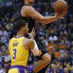Phoenix Suns guard Devin Booker (1) draws the foul from Los Angeles Lakers guard Josh Hart during the second half of an NBA basketball game Saturday, March 2, 2019, in Phoenix. The Suns won 118-109. (AP Photo/Rick Scuteri)