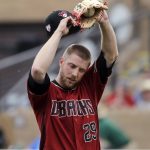 Arizona Diamondbacks starting pitcher Merrill Kelly stretches after giving up a hit to the Los Angeles Angels during the third inning of a spring training baseball game Thursday, March 21, 2019, in Scottsdale, Ariz. (AP Photo/Elaine Thompson)