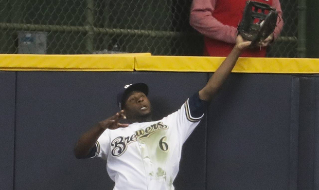 Milwaukee Brewers' Lorenzo Cain catches a ball at the wall hit by St. Louis Cardinals' Jose Martine...
