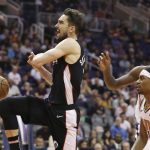 Washington Wizards guard Tomas Satoransky, left, is fouled by Phoenix Suns guard De'Anthony Melton, front right, as Suns center Deandre Ayton, back right, watches during the second half of an NBA basketball game Wednesday, March 27, 2019, in Phoenix. The Wizards won 124-121. (AP Photo/Ross D. Franklin)