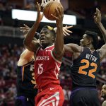 Houston Rockets' Clint Capela (15) goes up for a shot as Phoenix Suns' Deandre Ayton (22) and Dragan Bender defend during the second half of an NBA basketball game Friday, March 15, 2019, in Houston. The Rockets won 108-102. (AP Photo/David J. Phillip)