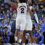 Arizona State's Rob Edwards, left, and Kimani Lawrence celebrate after Lawrence scored a 3-point shot against UCLA during the first half of an NCAA college basketball game in the quarterfinals of the Pac-12 men's tournament Thursday, March 14, 2019, in Las Vegas. (AP Photo/John Locher)