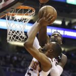 Washington Wizards forward Jeff Green, right, jumps to block the shot of Phoenix Suns forward Mikal Bridges (25) during the first half of an NBA basketball game Wednesday, March 27, 2019, in Phoenix. (AP Photo/Ross D. Franklin)