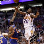 Phoenix Suns forward Josh Jackson (20) has his shot blocked by New York Knicks center Mitchell Robinson during the second half of an NBA basketball game Wednesday, March 6, 2019, in Phoenix. (AP Photo/Matt York)