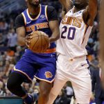 New York Knicks guard Emmanuel Mudiay shoots around Phoenix Suns forward Josh Jackson (20) during the first half of an NBA basketball game Wednesday, March 6, 2019, in Phoenix. (AP Photo/Matt York)