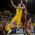 FILE - In this Jan. 22, 2019, file photo, Michigan forward Ignas Brazdeikis (13) goes to the basket, defended by Minnesota forward Eric Curry (24), in the second half of an NCAA college basketball game, in Ann Arbor, Mich. Brazdeikas was Newcomer of the Year in the Big Ten Conference, Tuesday, March 12, 2019. (AP Photo/Tony Ding, File)