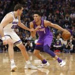 Phoenix Suns guard Devin Booker, right, drives against Sacramento Kings forward Nemanja Bjelica during the first quarter of an NBA basketball game Saturday, March 23, 2019, in Sacramento, Calif. (AP Photo/Rich Pedroncelli)
