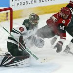 Arizona Coyotes right wing Josh Archibald (45) beats Minnesota Wild goaltender Devan Dubnyk (40) for a goal as Wild center Joel Eriksson Ek, right, knocks him to the ice during the second period of an NHL hockey game Sunday, March 31, 2019, in Glendale, Ariz. (AP Photo/Ross D. Franklin)