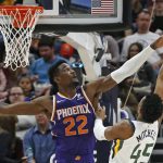 Phoenix Suns center Deandre Ayton (22) defends against Utah Jazz guard Donovan Mitchell (45) during the first half of an NBA basketball game Monday, March 25, 2019, in Salt Lake City. (AP Photo/Rick Bowmer)