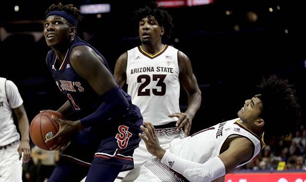 St. John's guard Bashir Ahmed, left, collides with Arizona State guard Remy Martin during the secon...