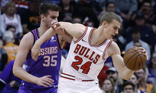 Chicago Bulls forward Lauri Markkanen (24) spins around Phoenix Suns forward Dragan Bender (35) dur...