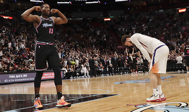 Miami Heat center Bam Adebayo (13) and Phoenix Suns guard Tyler Johnson, right, react during the se...