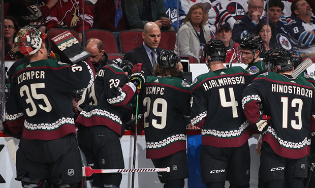 Head coach Rick Tocchet of the Arizona Coyotes talks with his team during the NHL game against the ...