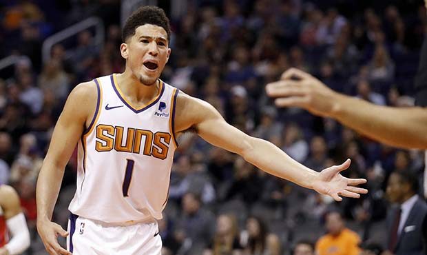 Phoenix Suns guard Devin Booker (1) argues with an official after being called for a technical foul...