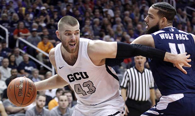 Grand Canyon's Michael Finke (43) pushes his way around Nevada's Cody Martin (11) during the first ...