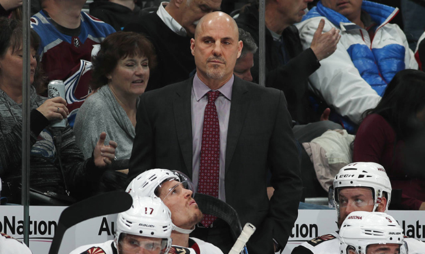 Arizona Coyotes head coach Rick Tocchet, center top, looks on in the second period of an NHL hockey...