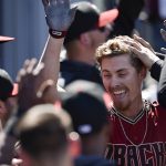 Arizona Diamondbacks' Luke Weaver celebrates with the dugout after hitting a two-run home run during the fourth inning of a baseball game against the Los Angeles Dodgers in Los Angeles, Sunday, March 31, 2019. (AP Photo/Kelvin Kuo)
