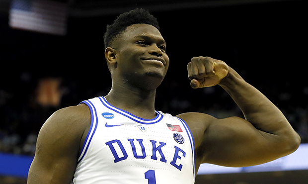 Zion Williamson #1 of the Duke Blue Devils reacts after scoring a basket and drawing a foul against...