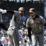 Arizona Diamondbacks' David Peralta, right, celebrates with Adam Jones, center, and Christian Walker after hitting a solo home run against the Chicago Cubs during the first inning of a baseball game Saturday, April 20, 2019, in Chicago. (AP Photo/Nam Y. Huh)