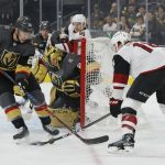 Vegas Golden Knights center Paul Stastny, left, knocks the puck away from Arizona Coyotes center Christian Dvorak during the first period of an NHL hockey game Thursday, April 4, 2019, in Las Vegas. (AP Photo/John Locher)