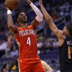 New Orleans Pelicans guard Elfrid Payton (4) shoots over Phoenix Suns guard De'Anthony Melton during the first half of an NBA basketball game Friday, April 5, 2019, in Phoenix. (AP Photo/Rick Scuteri)