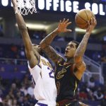 Cleveland Cavaliers guard Jordan Clarkson (8) drives to the basket against Phoenix Suns forward Josh Jackson, left, during the first half of an NBA basketball game Monday, April 1, 2019, in Phoenix. (AP Photo/Ross D. Franklin)