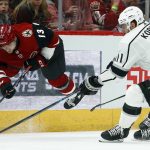 Arizona Coyotes center Vinnie Hinostroza (13) gets tripped up by Los Angeles Kings center Anze Kopitar (11) during the first period of an NHL hockey game, Tuesday, April 2, 2019, in Glendale, Ariz. (AP Photo/Ross D. Franklin)