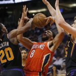 New Orleans Pelicans center Jahlil Okafor (8) battles for the loose ball with Phoenix Suns' Josh Jackson (20) and Dragan Bender during the first half of an NBA basketball game Friday, April 5, 2019, in Phoenix. (AP Photo/Rick Scuteri)
