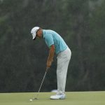Emiliano Grillo, of Argentina, putts in the rain on the 18th hole during the second round for the Masters golf tournament Friday, April 12, 2019, in Augusta, Ga. (AP Photo/Matt Slocum)