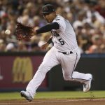 Arizona Diamondbacks third baseman Eduardo Escobar fields a ground ball before throwing out Boston Red Sox's Xander Bogaerts at first base during the fourth inning of a baseball game Friday, April 5, 2019, in Phoenix. (AP Photo/Ross D. Franklin)