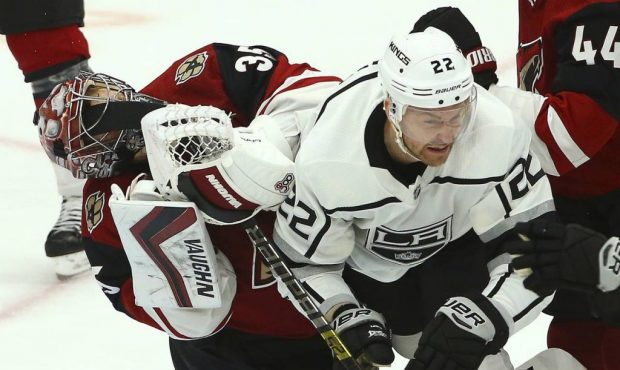 Los Angeles Kings center Trevor Lewis (22) gets Arizona Coyotes goaltender Darcy Kuemper (35) in th...
