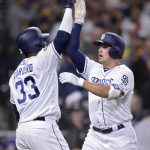 San Diego Padres' Hunter Renfroe is congratulated by Franchy Cordero (33) after hitting a home run during the seventh inning of a baseball game against the Arizona Diamondbacks, Tuesday, April 2, 2019, in San Diego. (AP Photo/Orlando Ramirez)